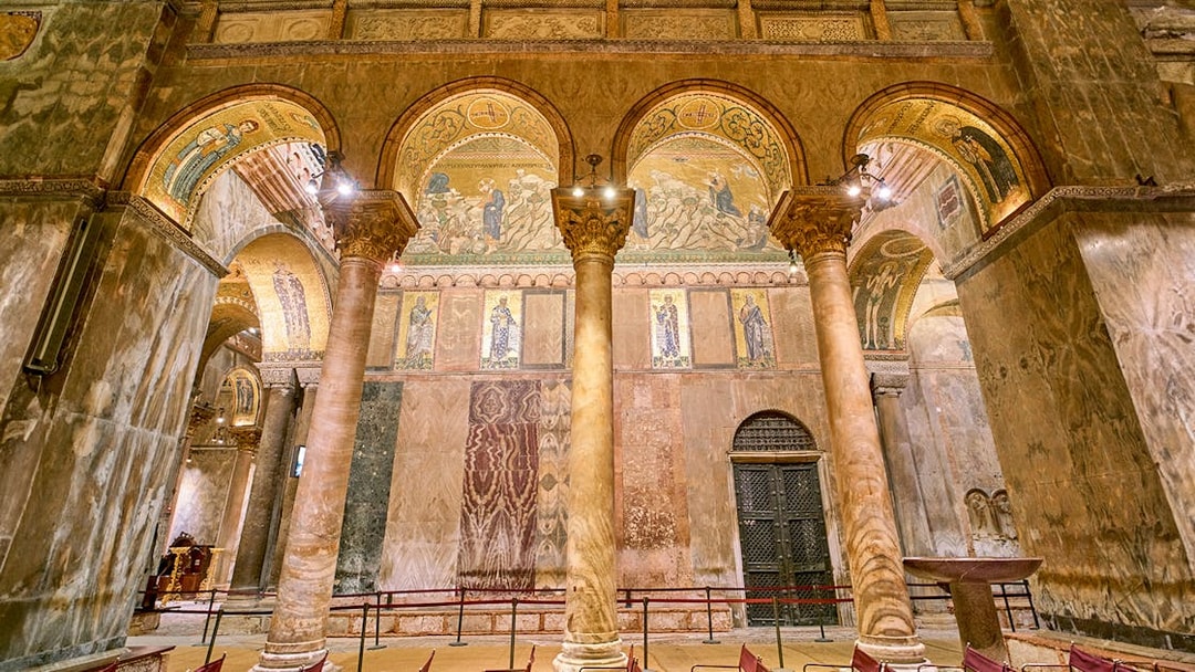 Interior of St. Mark's Basilica with ornate columns and mosaics, Venice.