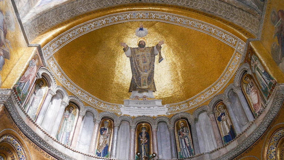 Mosaic ceiling inside St. Mark's Basilica, Venice, featuring religious figures and gold detailing.