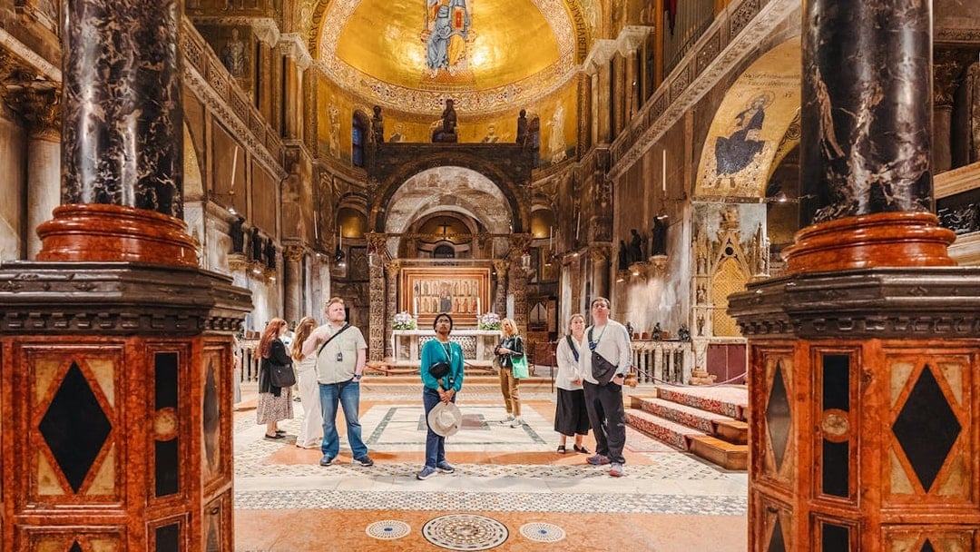 Visitors exploring St. Mark's Basilica interior during exclusive after-hours tour in Venice.