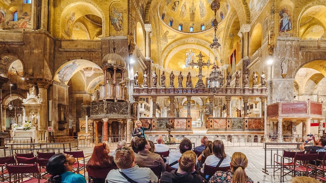 Tour group inside St. Mark's Basilica, Venice, admiring ornate interior after hours.