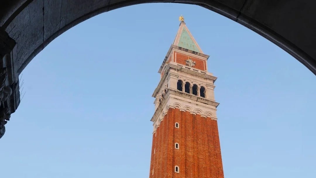 Bell tower of St. Mark's Basilica viewed through archway, Venice, Italy.