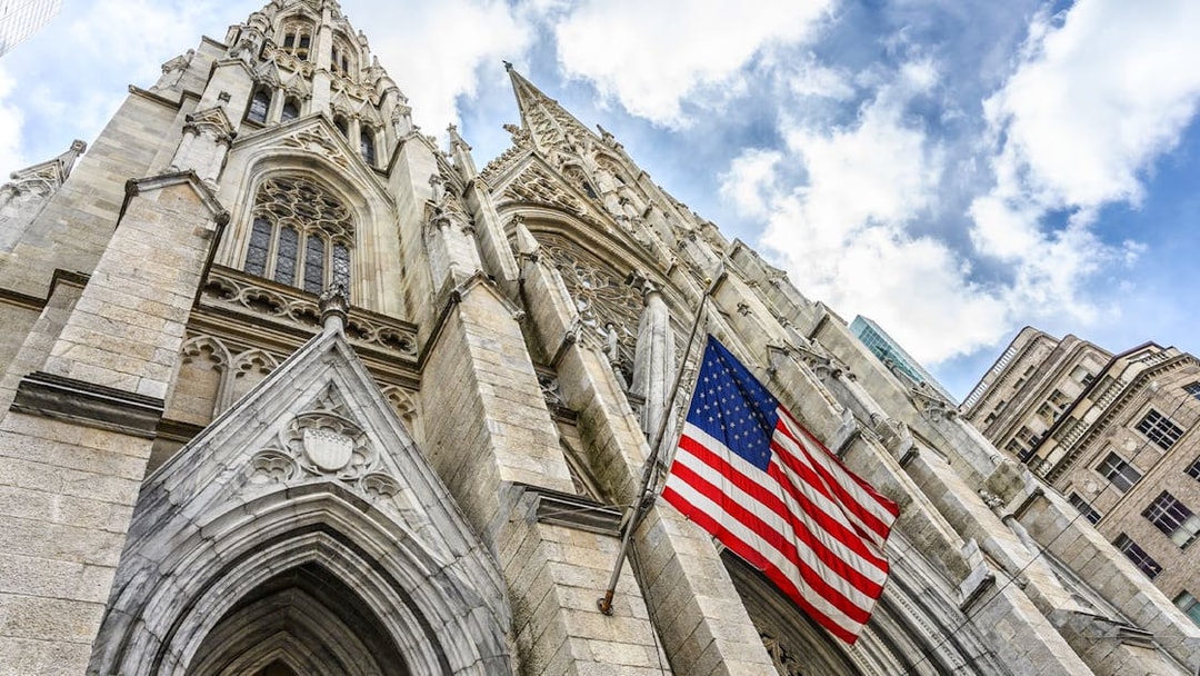 St. Patrick's Cathedral facade with American flag, New York City.