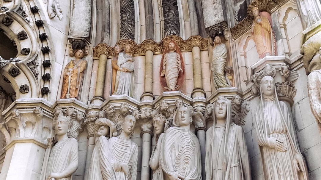 Stone sculptures on St. Patrick's Cathedral facade, showcasing detailed religious figures.