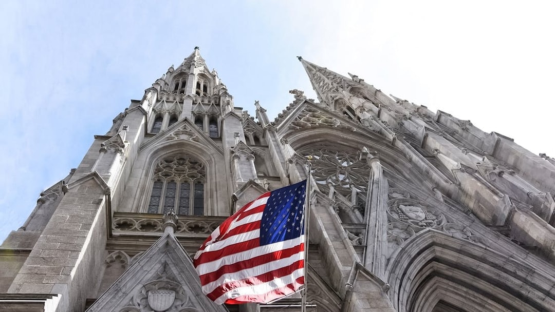 St. Patrick's Cathedral facade with American flag, New York City.