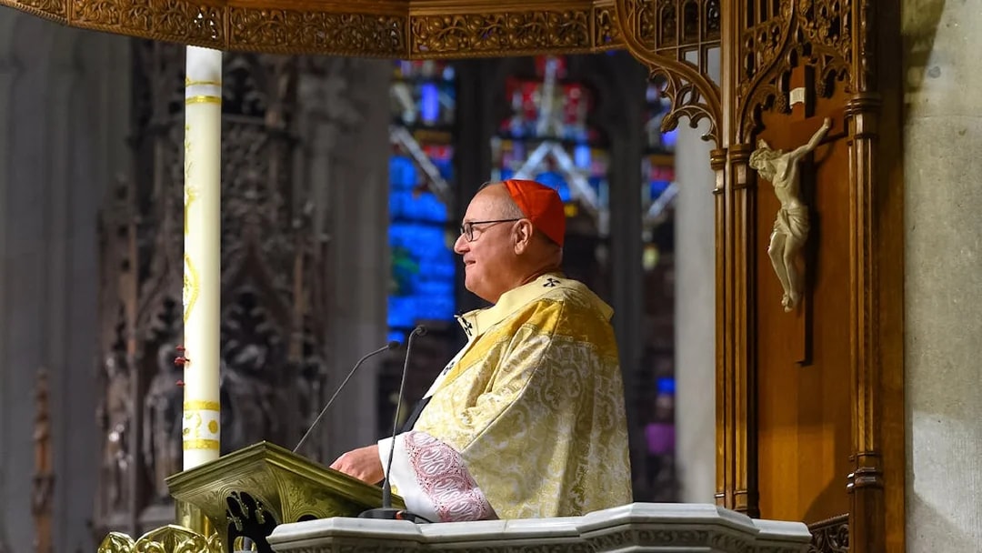 Clergy member speaking at St. Patrick's Cathedral event, New York City.