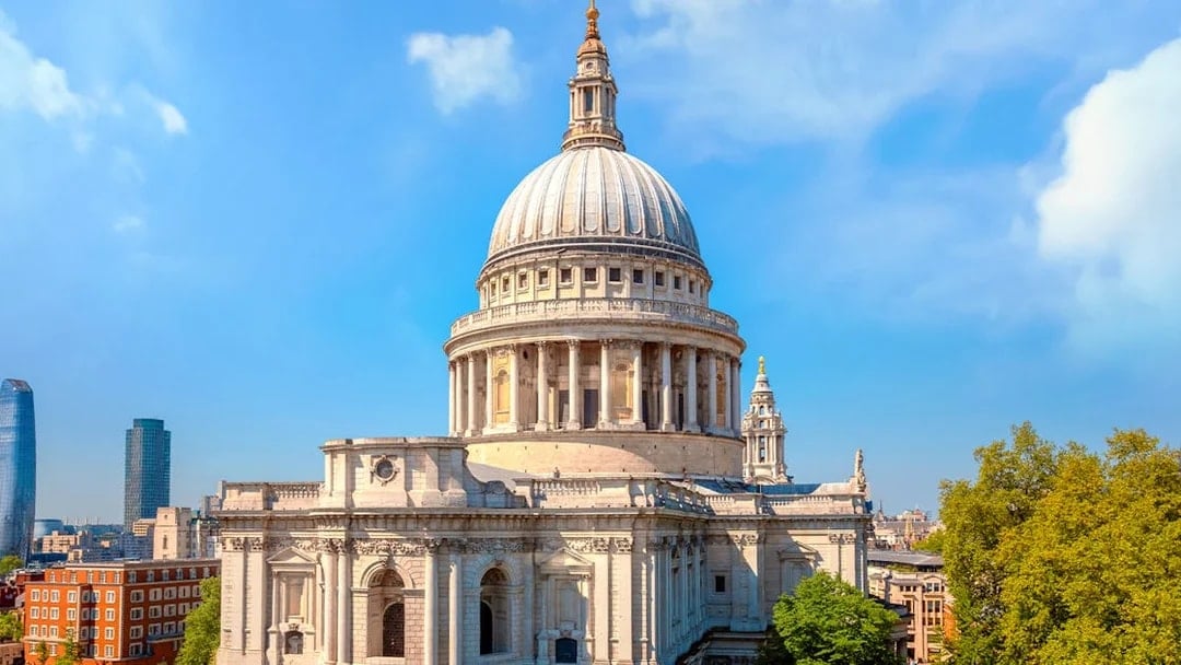 St. Paul's Cathedral dome with London skyline on a sunny day.