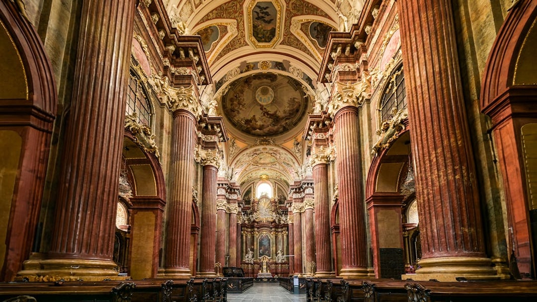 Interior of St Paul's Cathedral with ornate columns and detailed ceiling artwork.