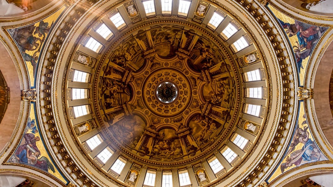 Intricate frescoes and architectural details on St. Paul's Cathedral dome, London.