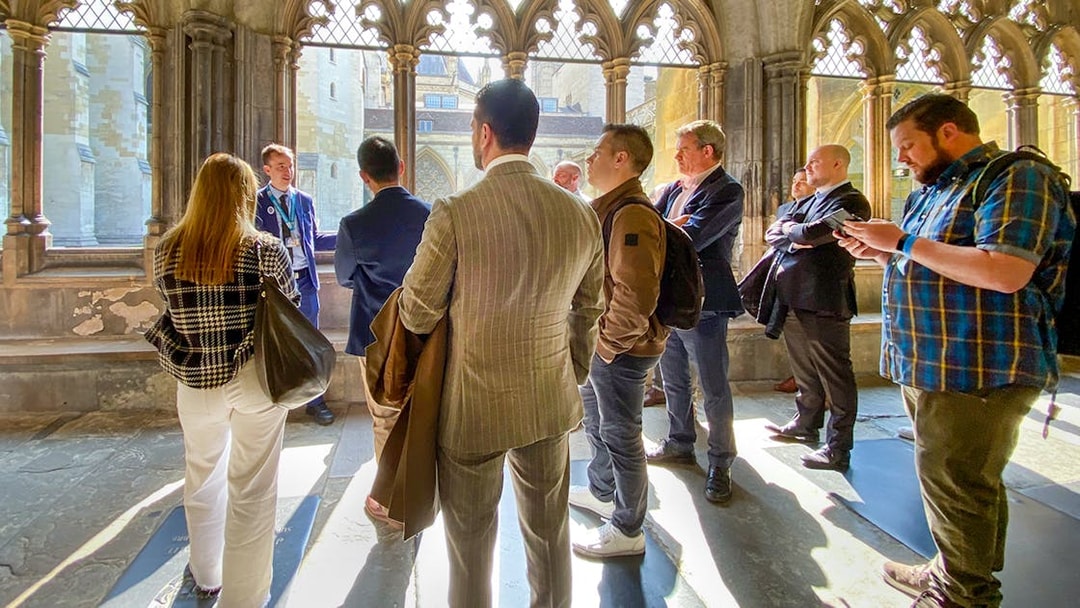 Tourists listening to a guide inside Westminster Abbey, London.