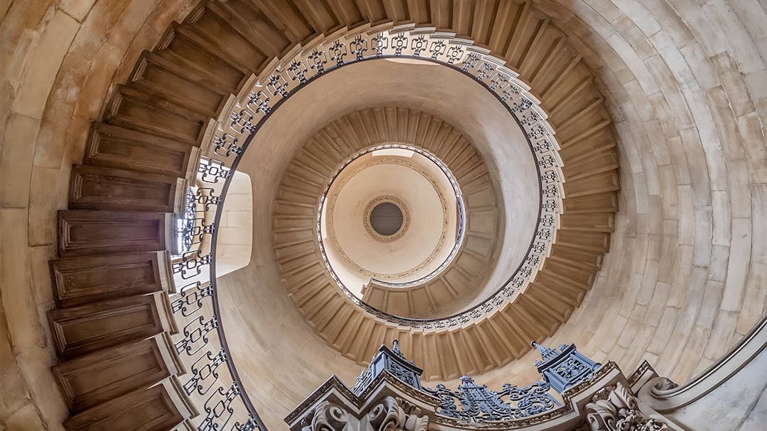 Spiral staircase inside St Paul's Cathedral, London, viewed from below.