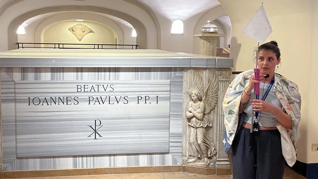 Tomb of Pope John Paul I in Vatican Grottoes, Vatican City, with a guide explaining.