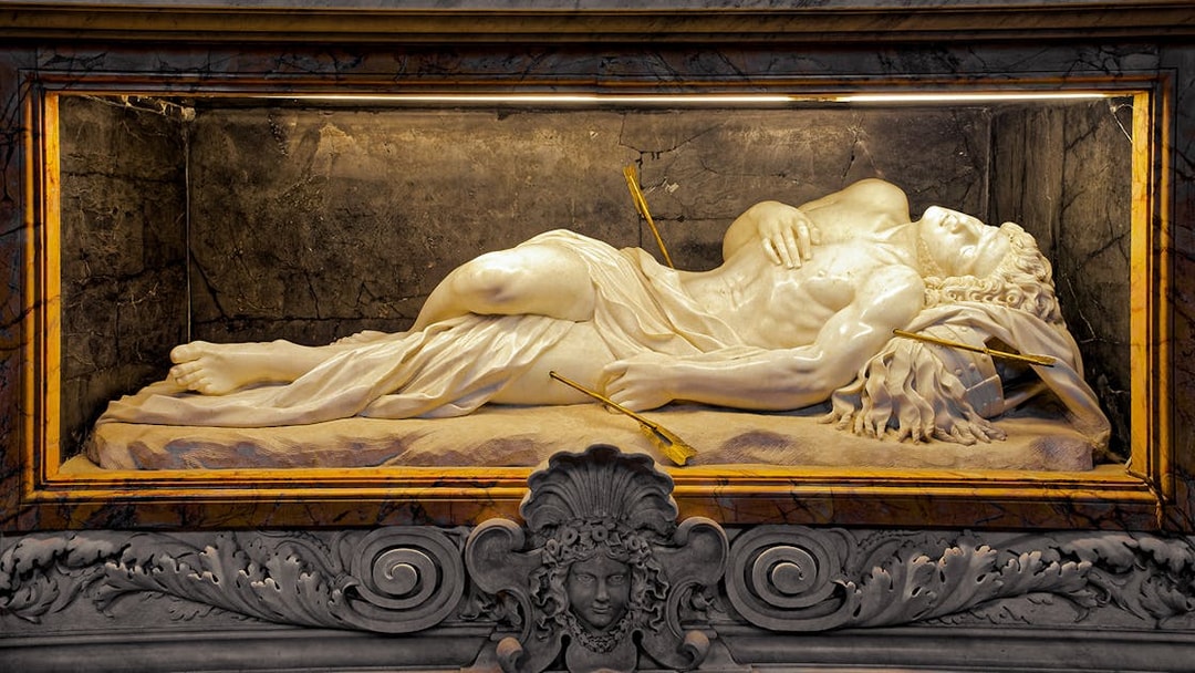 Marble sculpture of a reclining figure with arrows, St. Peter’s Basilica tour.