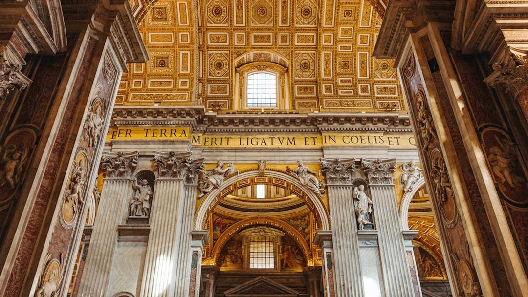 Interior view of St. Peter’s Basilica with ornate columns and detailed ceiling.