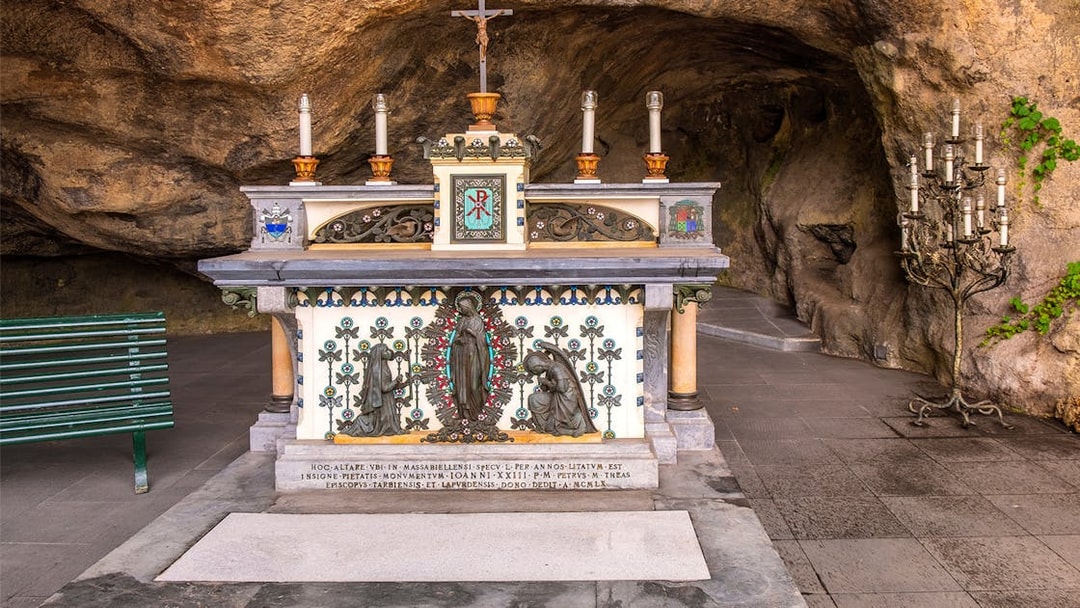 Altar in the Vatican Grottoes with religious statues and candles.