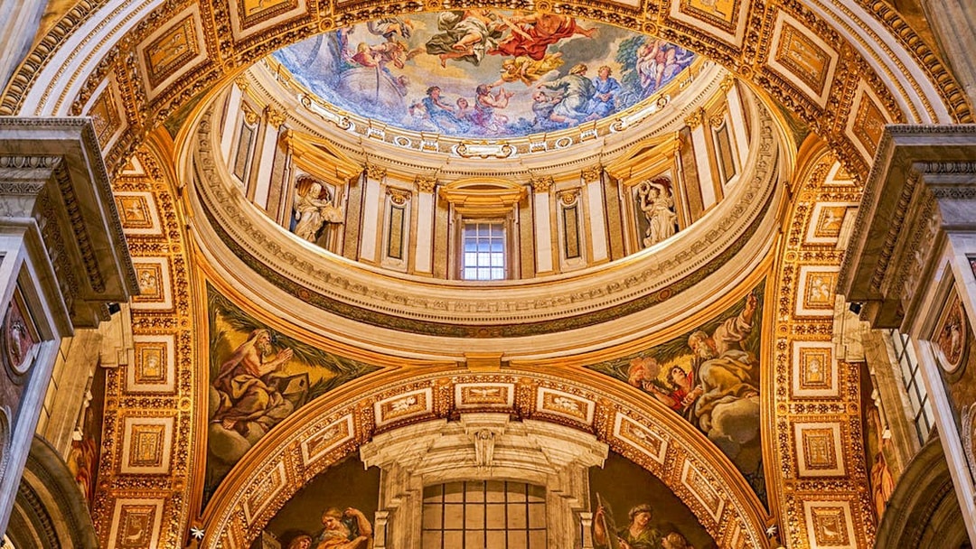 Paintings on the dome of St. Peter's Basilica, Vatican City, depicting religious scenes.