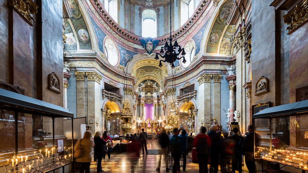 St. Peter's Church interior with visitors and lit candles during Christmas concert.