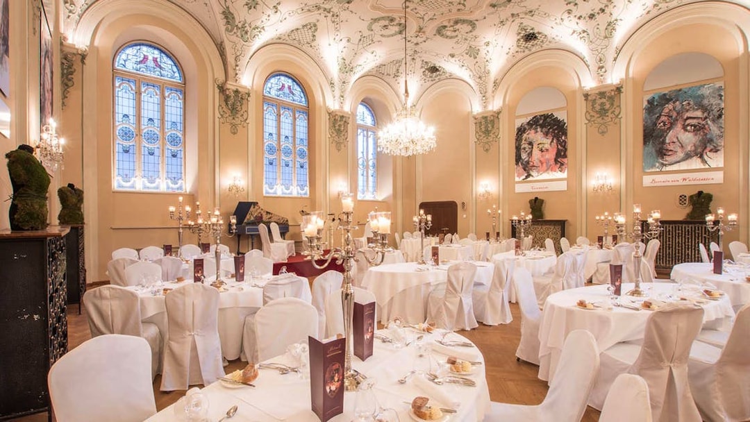 Elegant dining hall in Salzburg set for a Mozart concert with three-course dinner.