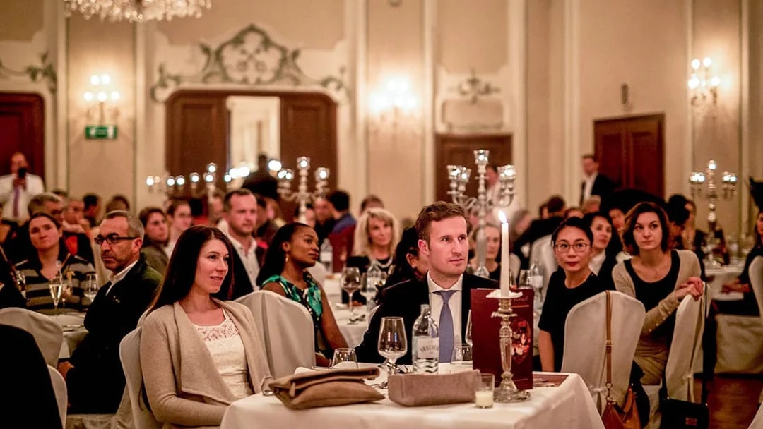 Audience enjoying a Mozart concert in Salzburg with musicians in period costumes in a historic venue.