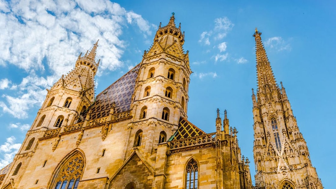 St. Stephen's Cathedral towers against a blue sky in Vienna, Austria.