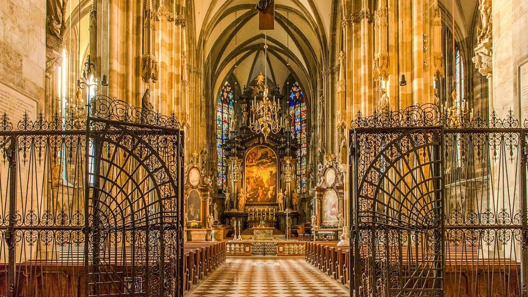 Interior view of St. Stephen's Cathedral in Vienna, featuring ornate gates and stained glass windows.