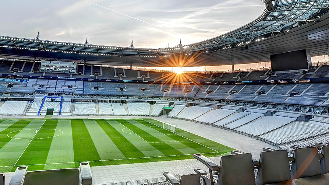 Stade de France interior with empty seats and field during guided tour.