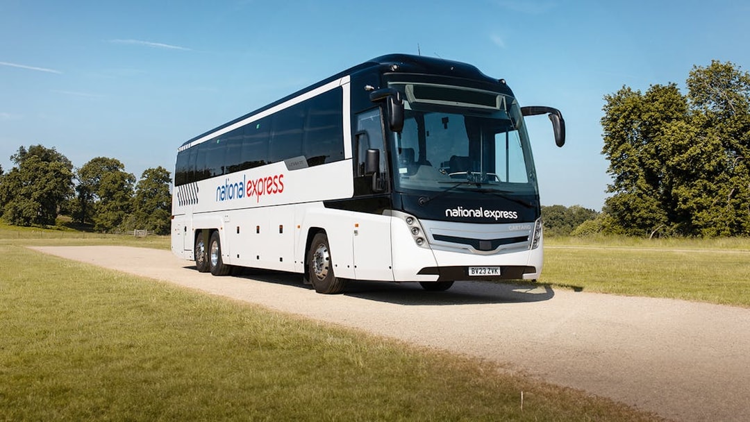 National Express bus traveling on a countryside road.