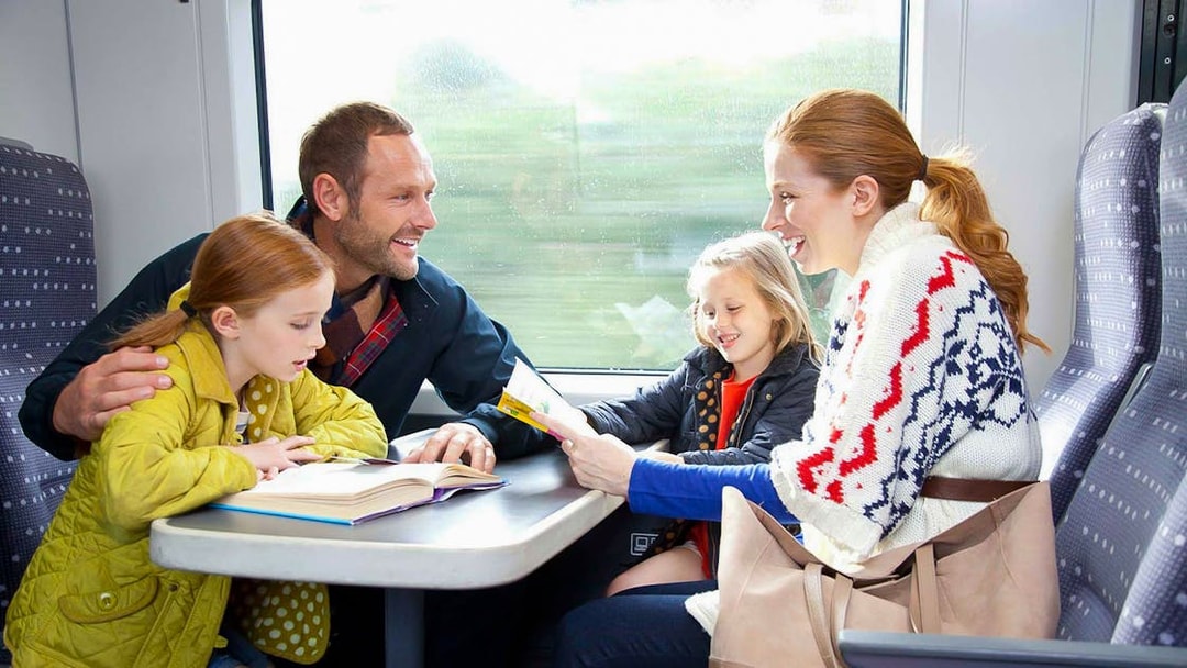 Family enjoying a train ride on Stansted Express from London Airport.
