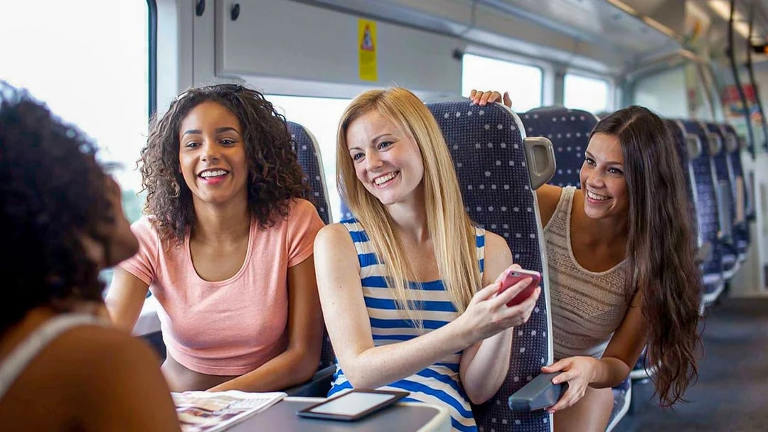 Women enjoying a conversation on the Stansted Express train.
