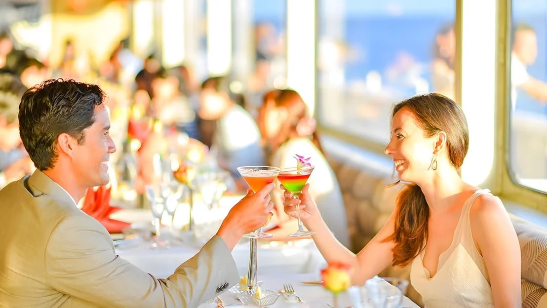 Couple toasting cocktails on Nova Five Star 2 cruise dining experience.