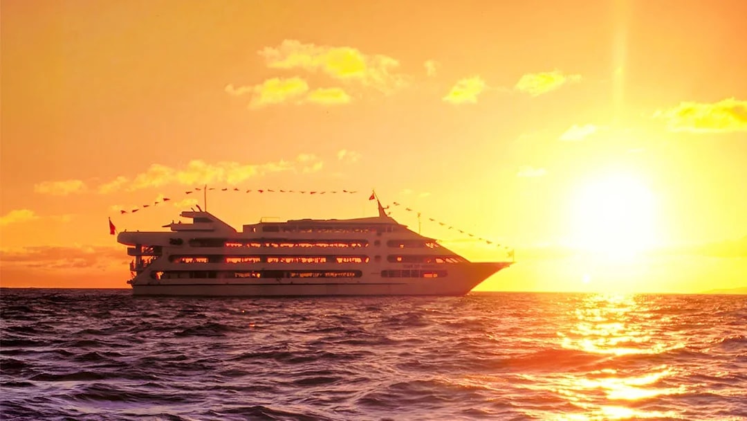 Star of Honolulu cruise ship sailing at sunset in Hawaii.