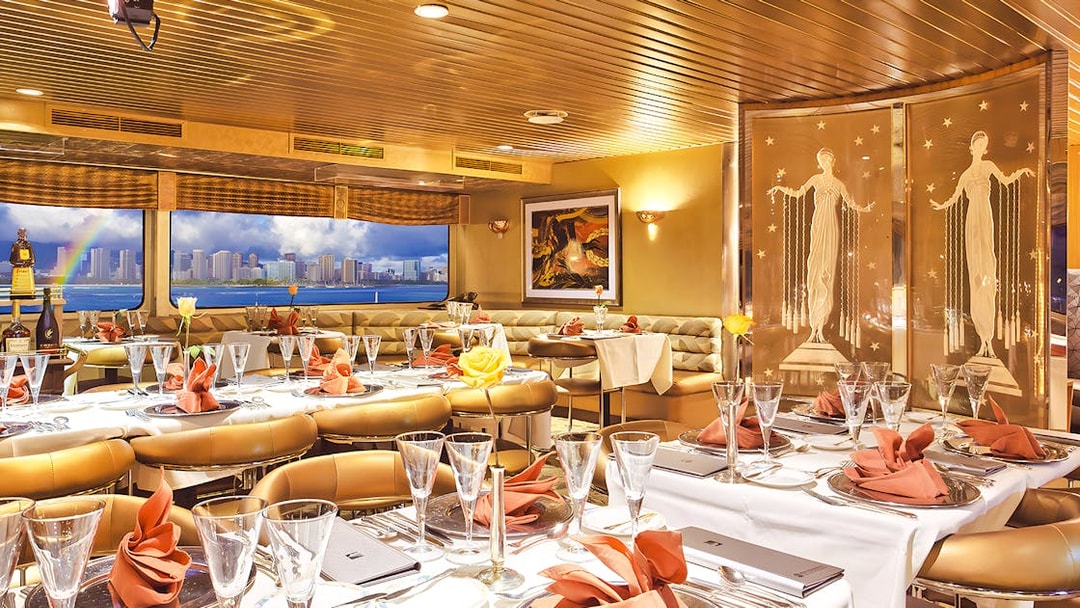 Dining area inside Nova Five Star 2 with elegant table settings and city skyline view.