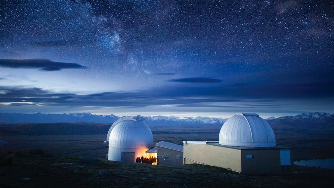 Mt. John Observatory domes under starry sky, Lake Tekapo, New Zealand.