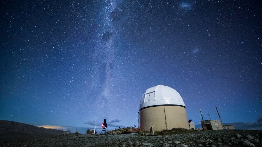 Mt. John Observatory under starry sky during stargazing experience in New Zealand.