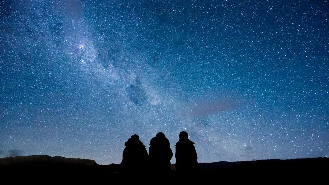 Stargazing at Mt. John Observatory under a star-filled sky.