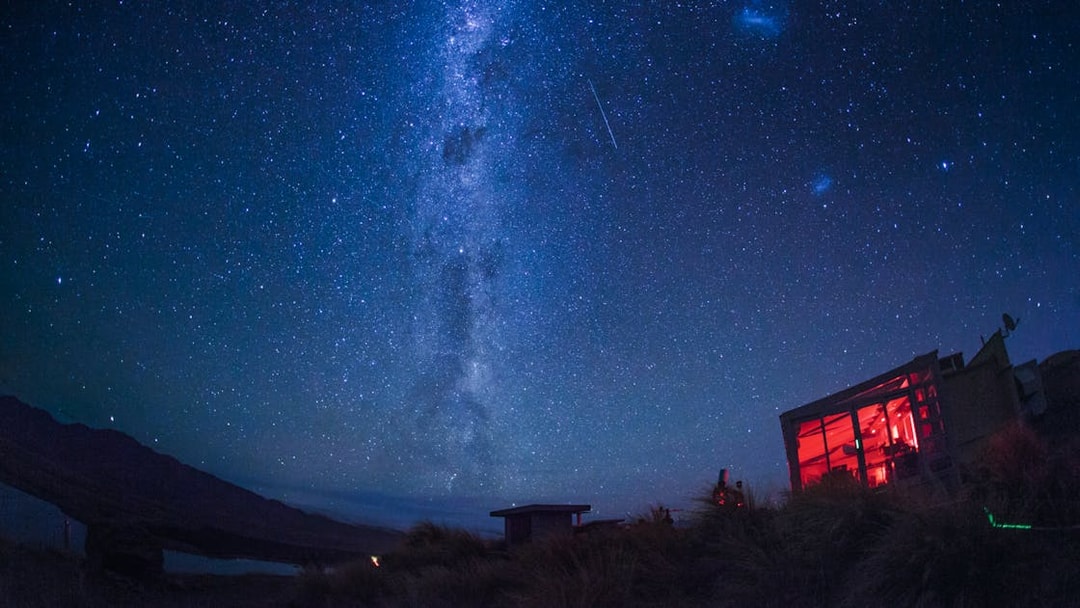 Stargazing at Mt. John Observatory under a starry sky with visible Milky Way.