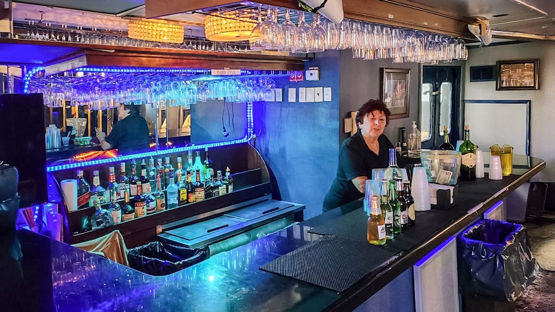 Bar setup on Statue of Liberty Ellis Island Sunset Cruise with bartender and drinks.