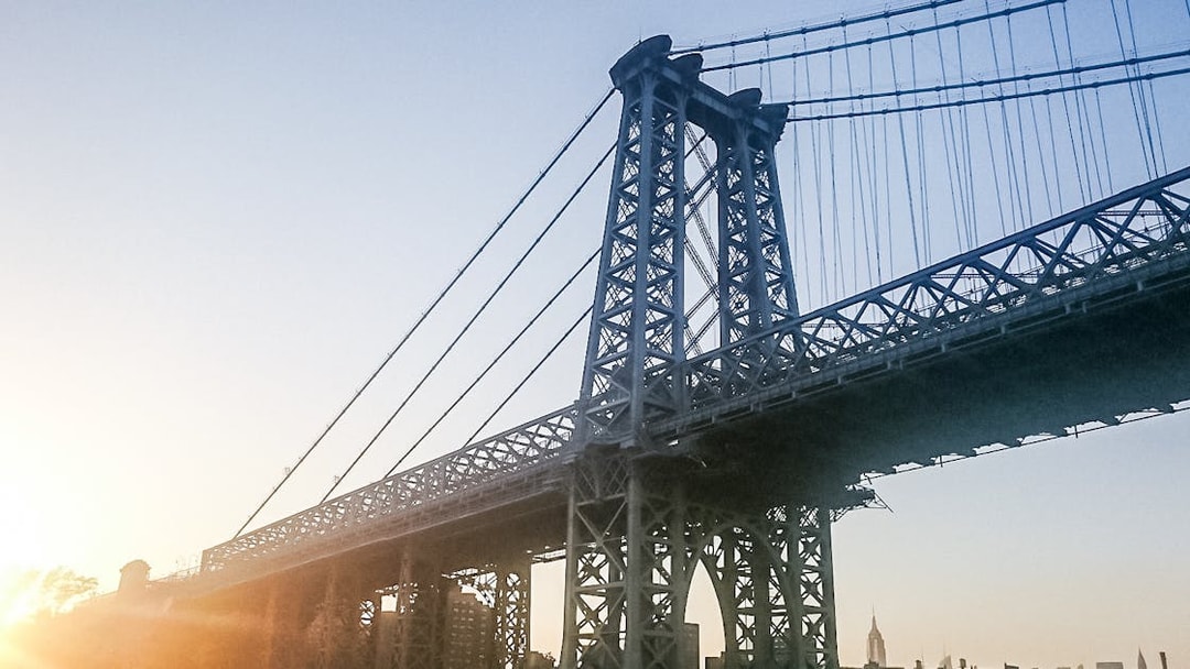 Williamsburg Bridge at sunset during Statue of Liberty Ellis Island cruise.