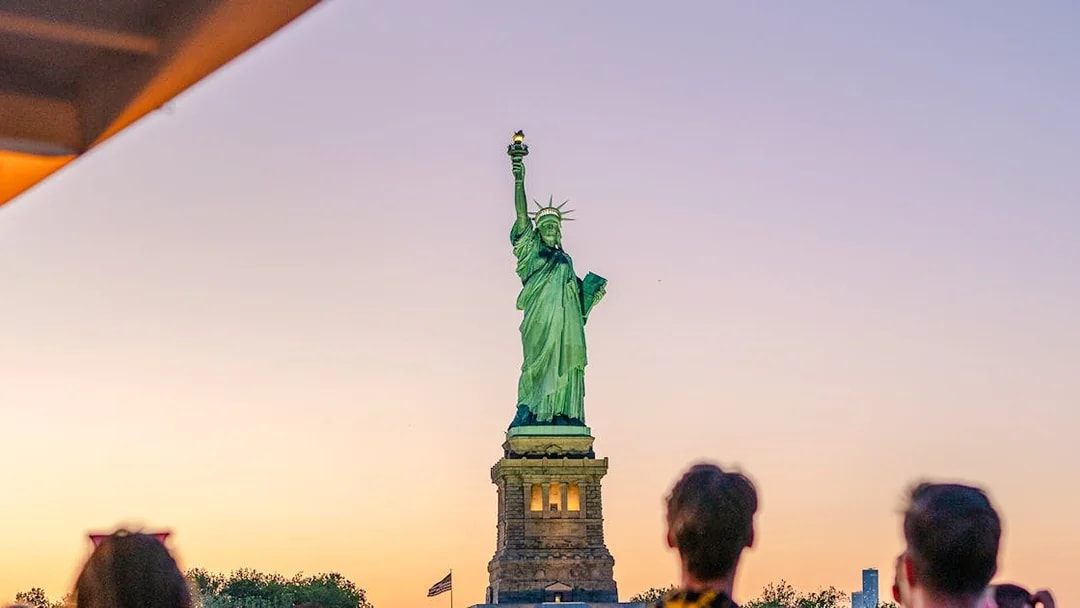 Statue of Liberty at sunset viewed from Circle Line cruise, New York City.