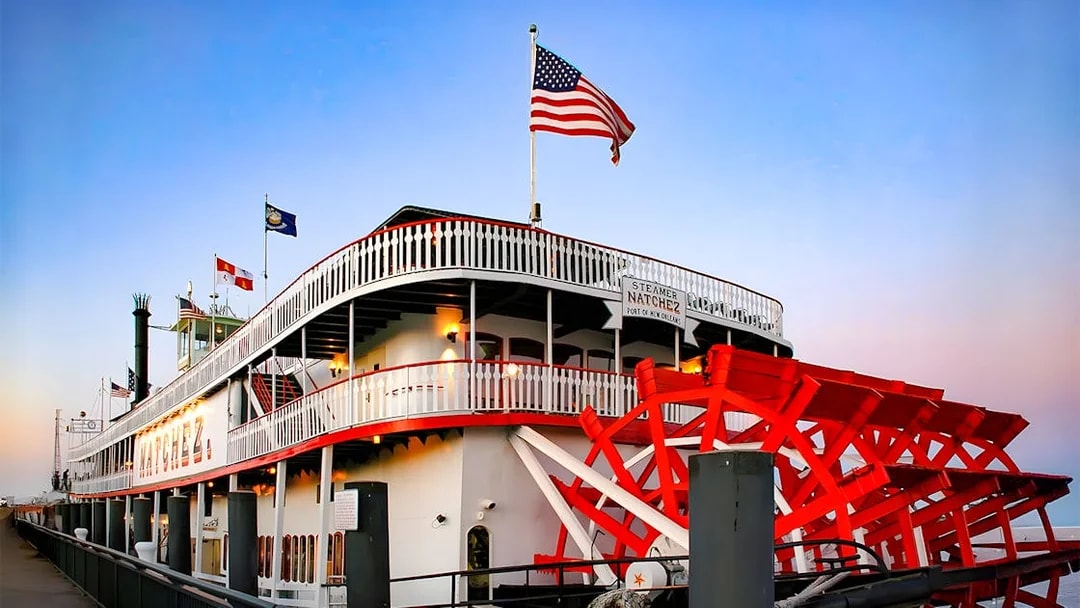 Steamboat Natchez docked in New Orleans, ready for dinner cruise boarding.