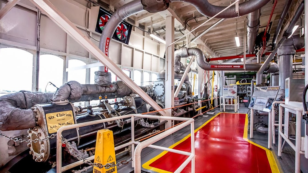 Steamboat Natchez engine room with machinery and steam pipes.
