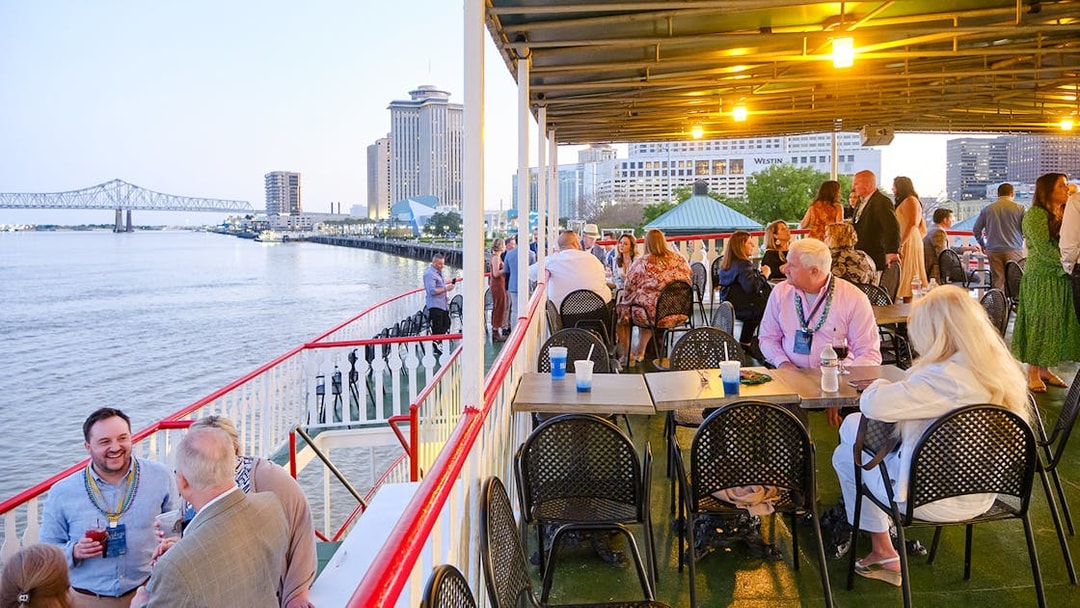 People enjoying the river view from the deck of Steamboat Natchez in New Orleans.
