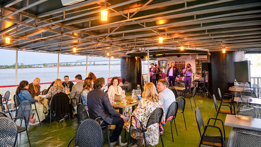 Guests dining while Dukes play live jazz on Steamboat Natchez cruise in New Orleans.
