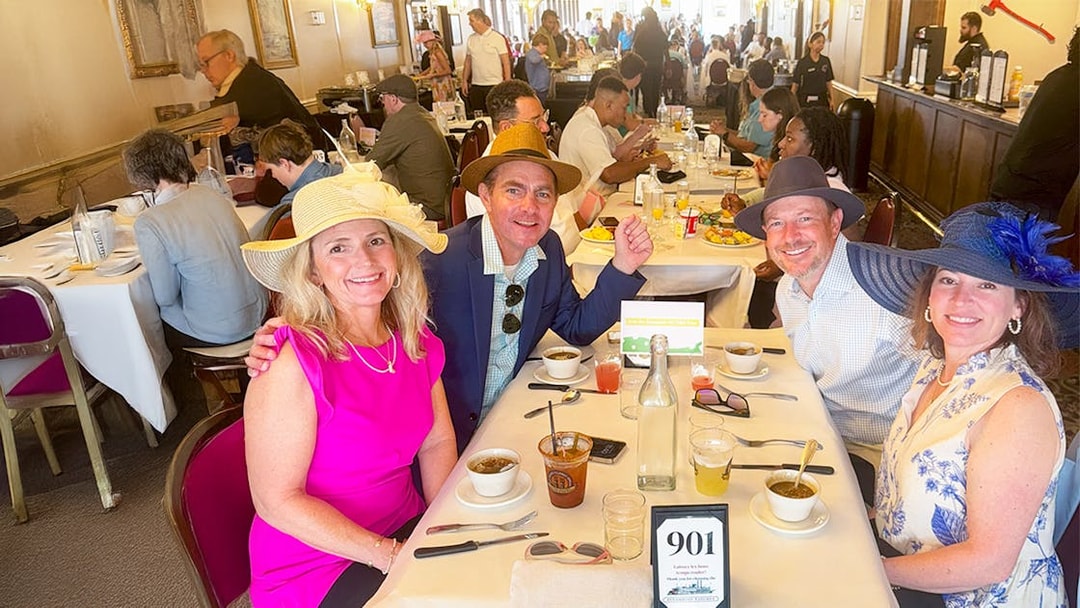 Guests enjoying brunch on Steamboat Natchez in a lively dining room.