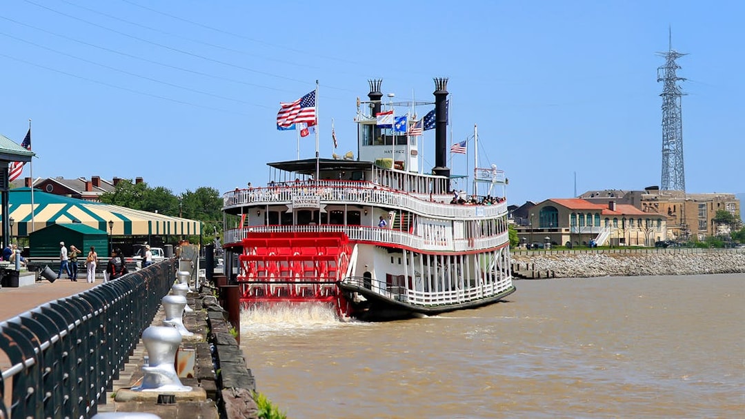 People walking toward Steamboat Natchez docked in the French Quarter, New Orleans.