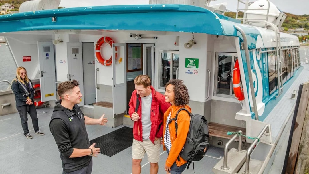 Crew assisting tourists boarding the Stewart Island Ferry.