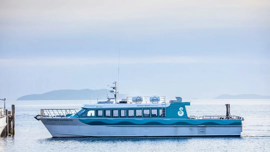 Stewart Island Ferry docked with distant islands in the background.