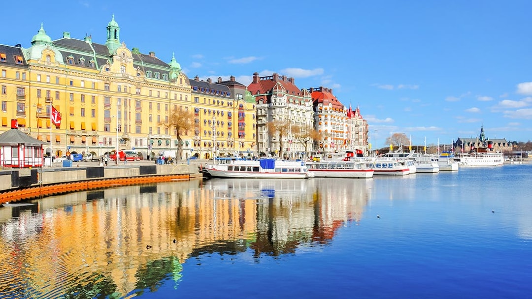 Canal cruise boats docked along Strandvagen embankment, Djurgrden City.