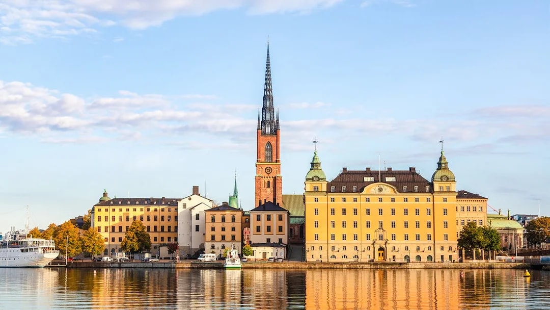 Djurgrden City Canal Cruise view of Gamla Stan, Stockholm's old town, with historic buildings and spire.