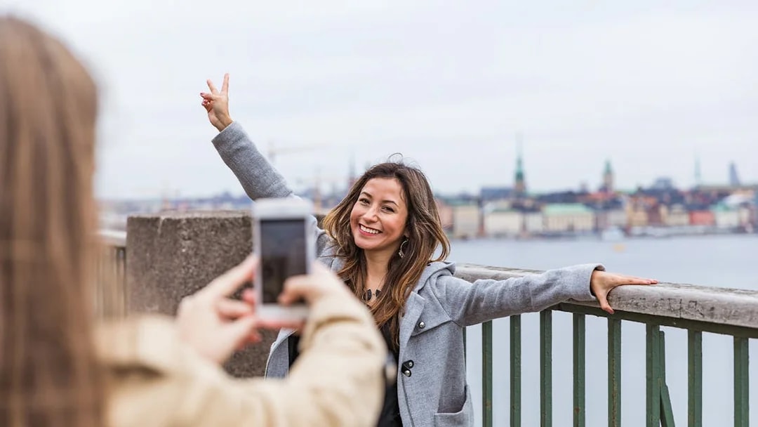 Person posing for a photo with Stockholm skyline in the background.
