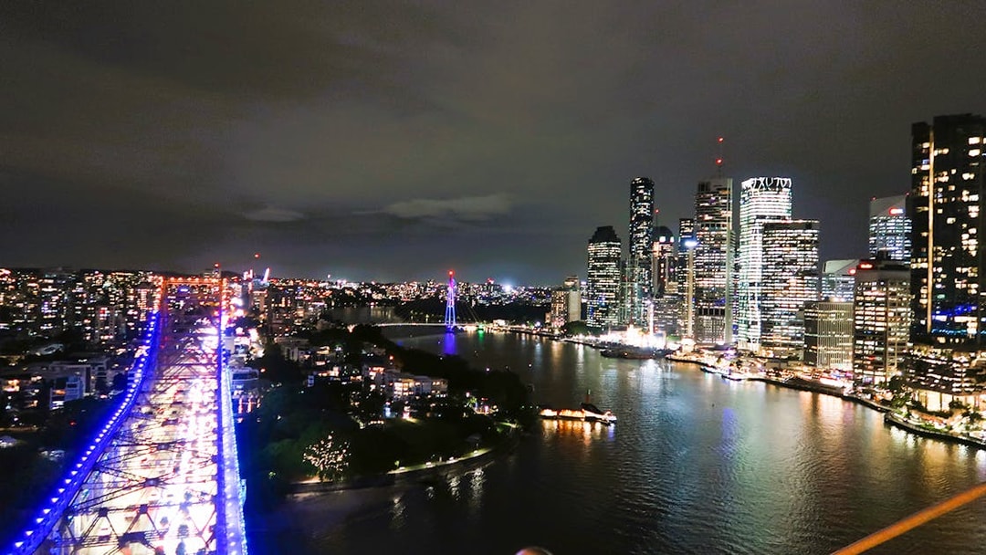 Night view from Story Bridge Adventure Climb, overlooking Brisbane city skyline and river.